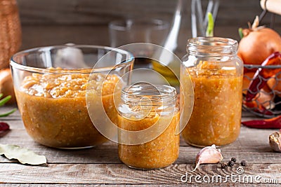 Vegetable caviar in a glass jar on a wooden table Stock Photo