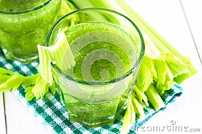 Vegetable cocktail made from celery leaves, healthy lifestyle on a white wooden background. Stock Photo