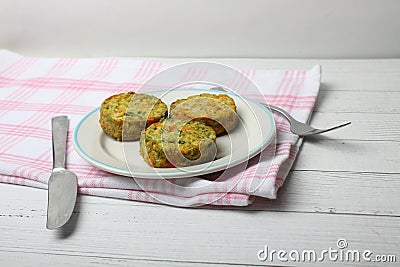 Vegetable cutlets on a plate and table-ware on a napkin Stock Photo