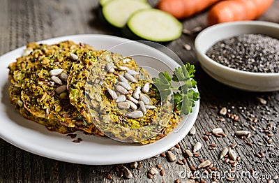 Vegetable pancakes with zucchini, carrot, chia, flax seeds and oatmeal Stock Photo