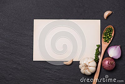 Vegetable recipe. Open menu book with fresh herbs and spices on Stock Photo