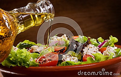 Vegetable salad with olive oil pouring from a bott Stock Photo