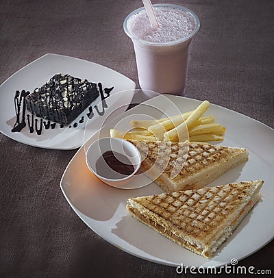Vegetable sandwich-Black forest pastry-Rose milk shake Stock Photo