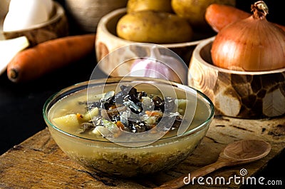 Vegetable soup mushrooms glass bowl wooden spoon Stock Photo