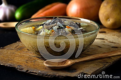 Vegetable soup mushrooms glass bowl wooden tureen Stock Photo