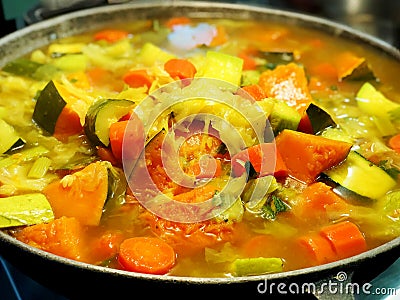 Vegetable stew with fillets on a plate.Stewed carrots, green beans, red beans, peas, corn, peppers and onions with chicken fillet. Stock Photo