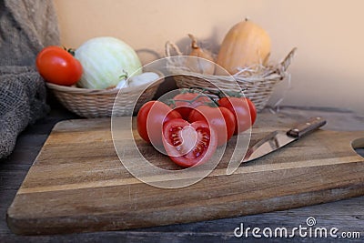 vegetable stocks are laid out on wooden shelf, ripe red tomatoes, head of cabbage in basket, garlic, pumpkin, onions, old dishes, Stock Photo