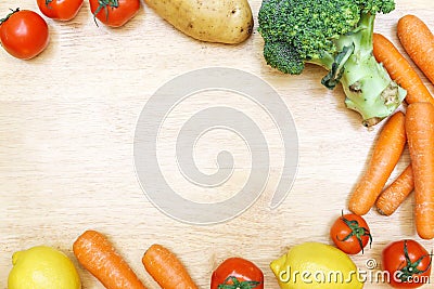 Vegetable tomato potato carrot broccoli lemon on wooden table wi Stock Photo