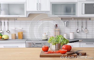 Vegetables and blurred view of kitchen interior on background Stock Photo