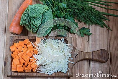 Vegetables cabbage carrots onions dill parsley. fresh vegetables on a wooden table Stock Photo