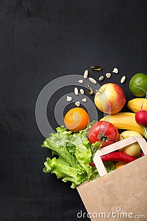 Vegetables and fruits in a paper bag on a white background with space for text. Vitamins on the table. Food delivery. Stock Photo