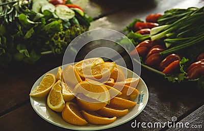 Vegetables and fruits are sliced on a wooden table. Picnic in the summer. Fresh vegetables. Party in nature Stock Photo