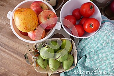 Vegetables and fruits at a wooden table. Tomatoes, apples and Pears Stock Photo
