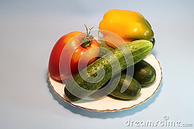 Vegetables in a plate on a gray background. Stock Photo