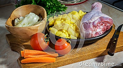 Vegetables - potatoes, tomatoes, onions, carrots and drumstick of a Turkey prepared for cooking soup Stock Photo