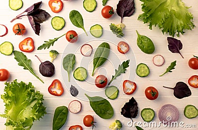 Vegetables for salad, cut into wedges on a white wooden background. Layout for poster, menu, advertisement Stock Photo