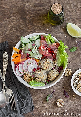 Vegetarian buddha bowl - quinoa meatballs and vegetable salad on wooden background, top view. Healthy, vegetarian food Stock Photo