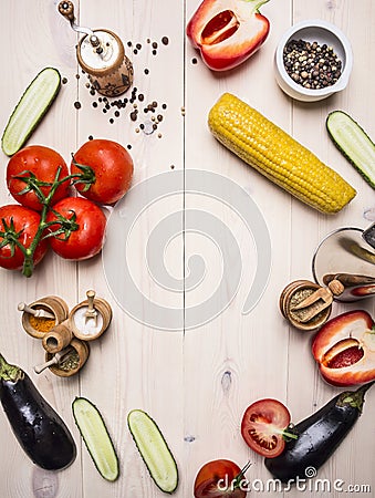 Vegetarian concept tomatoes, whole pepper, red bell pepper, corn, cucumbers and seasonings wooden rustic background top view cl Stock Photo