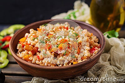 Vegetarian crumbly pearl barley porridge with vegetables Stock Photo