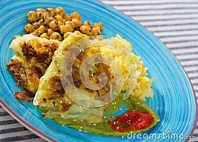 Vegetarian dish of leaves of cabbage in batter with sauces and chickpea Stock Photo