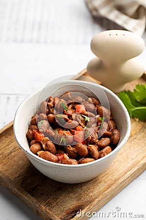 Vegetarian dish of stewed pink beans and tomatoes. A delicious bean dish served Stock Photo