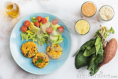 Vegetarian food. Healthy Food. Fried patties with salad on a plate.Made with sweet potato, lentils, millet, oats and spinach.White Stock Photo