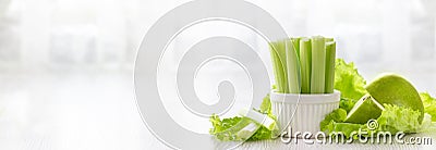 Vegetarian healthy food concept. Green celery, lettuce leaves and aplle Stock Photo