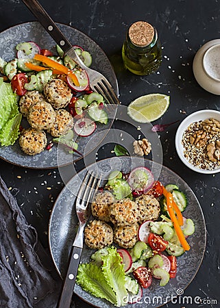 Vegetarian lunch - quinoa meatballs and vegetable salad on a dark table Stock Photo