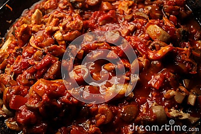 Vegetarian mushrooms chickpea stew in a iron pan on a dark background, top view Stock Photo