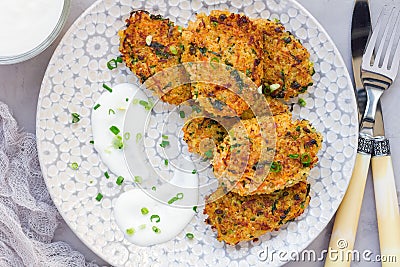 Vegetarian quinoa, carrot, coriander and green onion fritters served with yogurt on plate, horizontal, top view Stock Photo