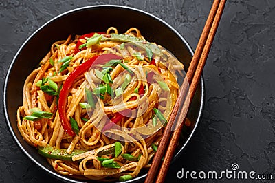 Vegetarian Schezwan Noodles or Vegetable Hakka Noodles or Chow Mein in black bowl at dark background. Schezwan Noodles is indo- Stock Photo