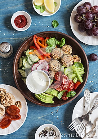 Vegetarian snack set - quinoa meatballs, fresh raw vegetables, grapes, dried fruits on wooden table, top view. Stock Photo