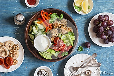 Vegetarian snack table - quinoa meatballs, fresh raw vegetables, grapes, dried fruits on wooden table, top view. Stock Photo