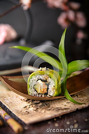 Vegetarian sushi rolls avocado with cream Philadelphia cheese, sesame, unagi sauce. Sushi menu. Stock Photo