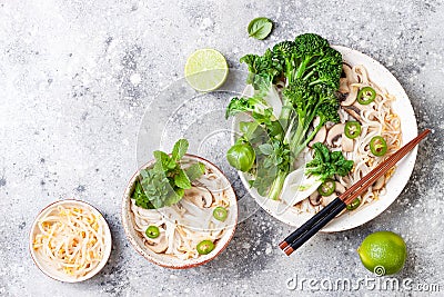 Vegetarian traditional Vietnamese soup Pho bo with herbs, rice noodles, broccolini, bok choy. Asian food concept. Stock Photo