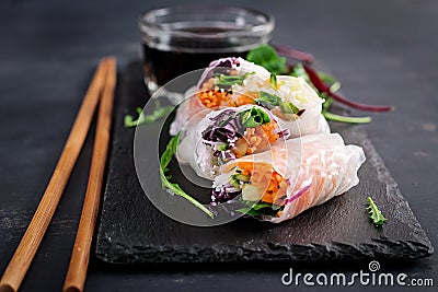 Vegetarian vietnamese spring rolls with spicy sauce, carrot, cucumber Stock Photo