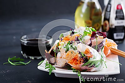 Vegetarian vietnamese spring rolls with spicy shrimps, prawns, carrot, cucumber Stock Photo