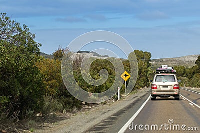 Vehicle with camping equipments on top driving on Cape du Couedic road on Kangaroo Island, South Australia Stock Photo