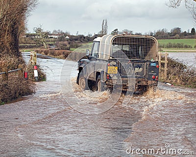 Vehicle Driving Through Flood Water On Road Editorial Stock Photo