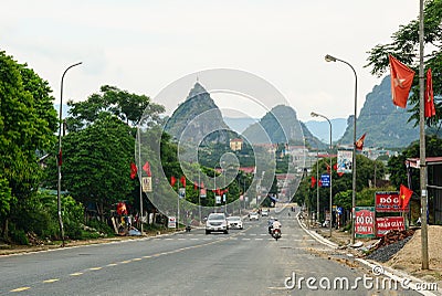 Vehicle driving on rural road with mountain background Editorial Stock Photo