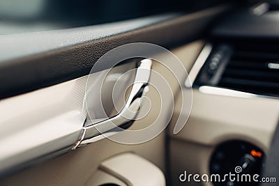 Vehicle interior door release lever. a visual describing the details, cleanliness and design of the vehicle interior Stock Photo