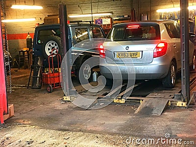 Vehicle on lift in garage or workshop Editorial Stock Photo