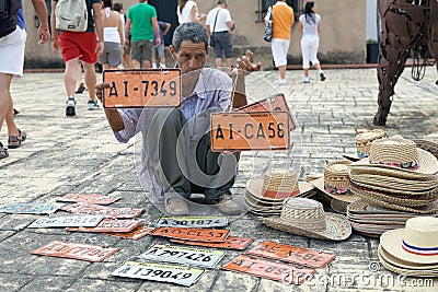 Vehicle registration plates and hat vendor Editorial Stock Photo