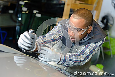 Vehicle worker fixing body Stock Photo