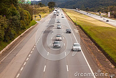 Vehicles on BR-374 highway with headlights on during the daylight obeying the new Brazilian transit laws Editorial Stock Photo