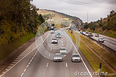 Vehicles on BR-374 highway with headlights on during the daylight obeying the new Brazilian transit laws Editorial Stock Photo
