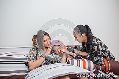 veiled girl cries and is comforted by her two friends Stock Photo