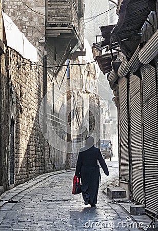 Veiled woman on old town street in aleppo syria Editorial Stock Photo