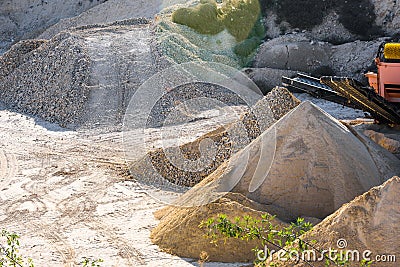 Velt conveyors and a piles of rubble in gravel quarry, crushed sand in different sizes Stock Photo