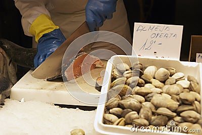 A vendor cutting fish at the Boqueria market Stock Photo